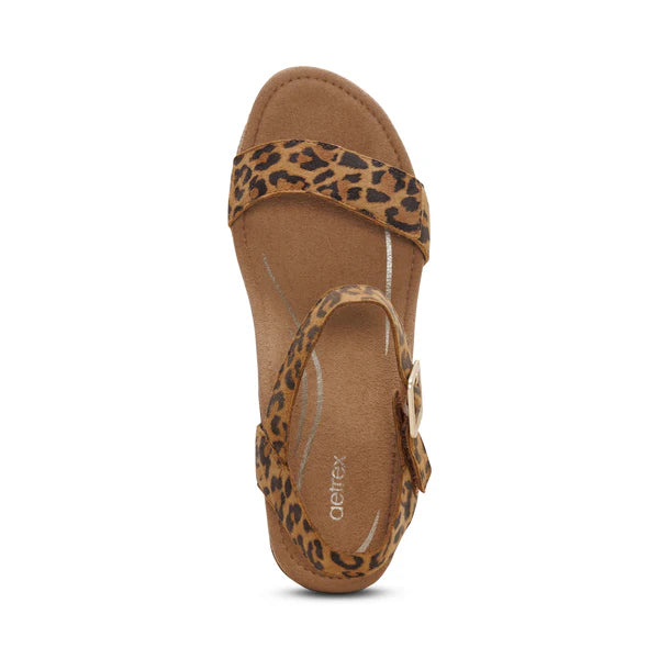 Brown sandal with leopard print straps on a white background