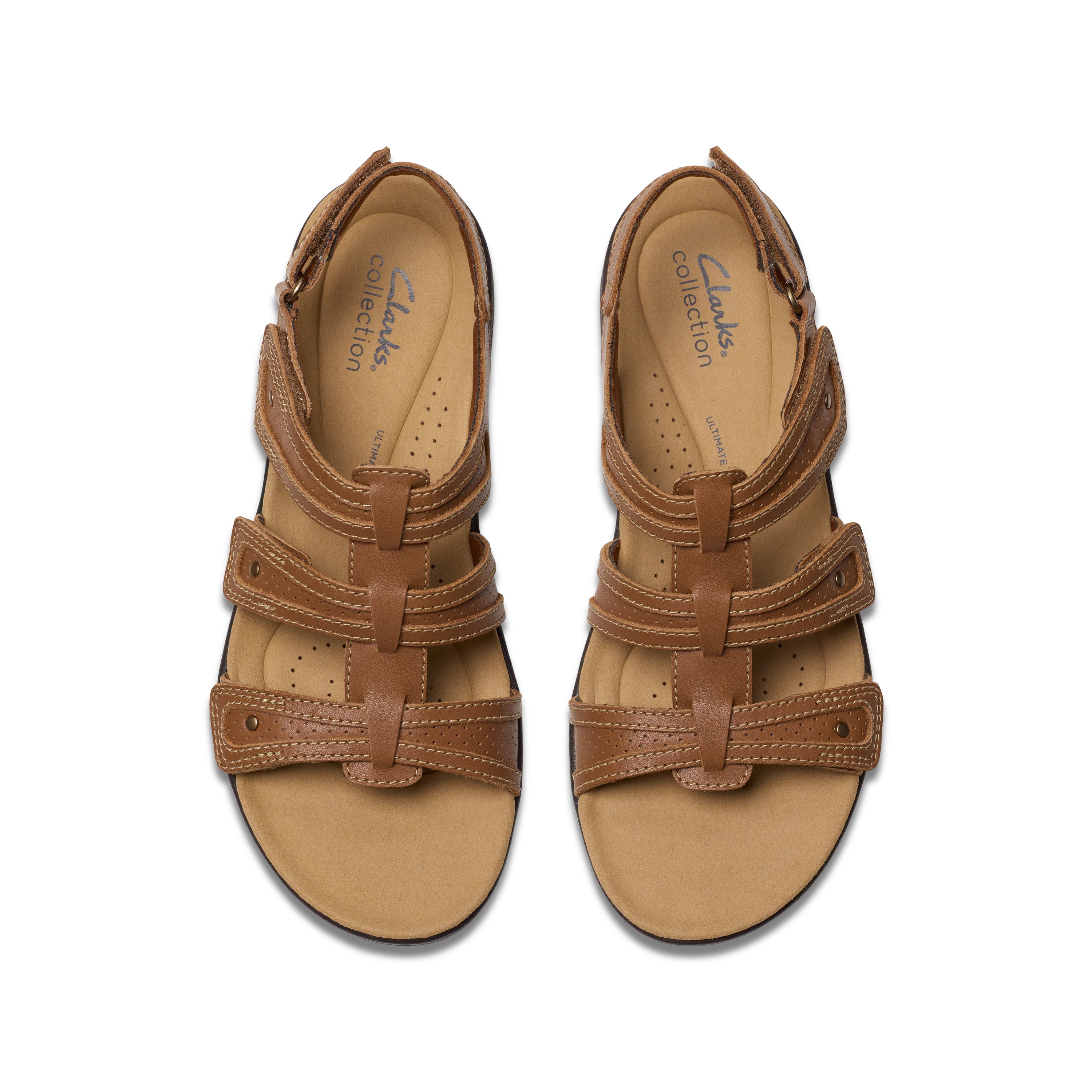 Pair of brown sandals with multiple straps on a white background