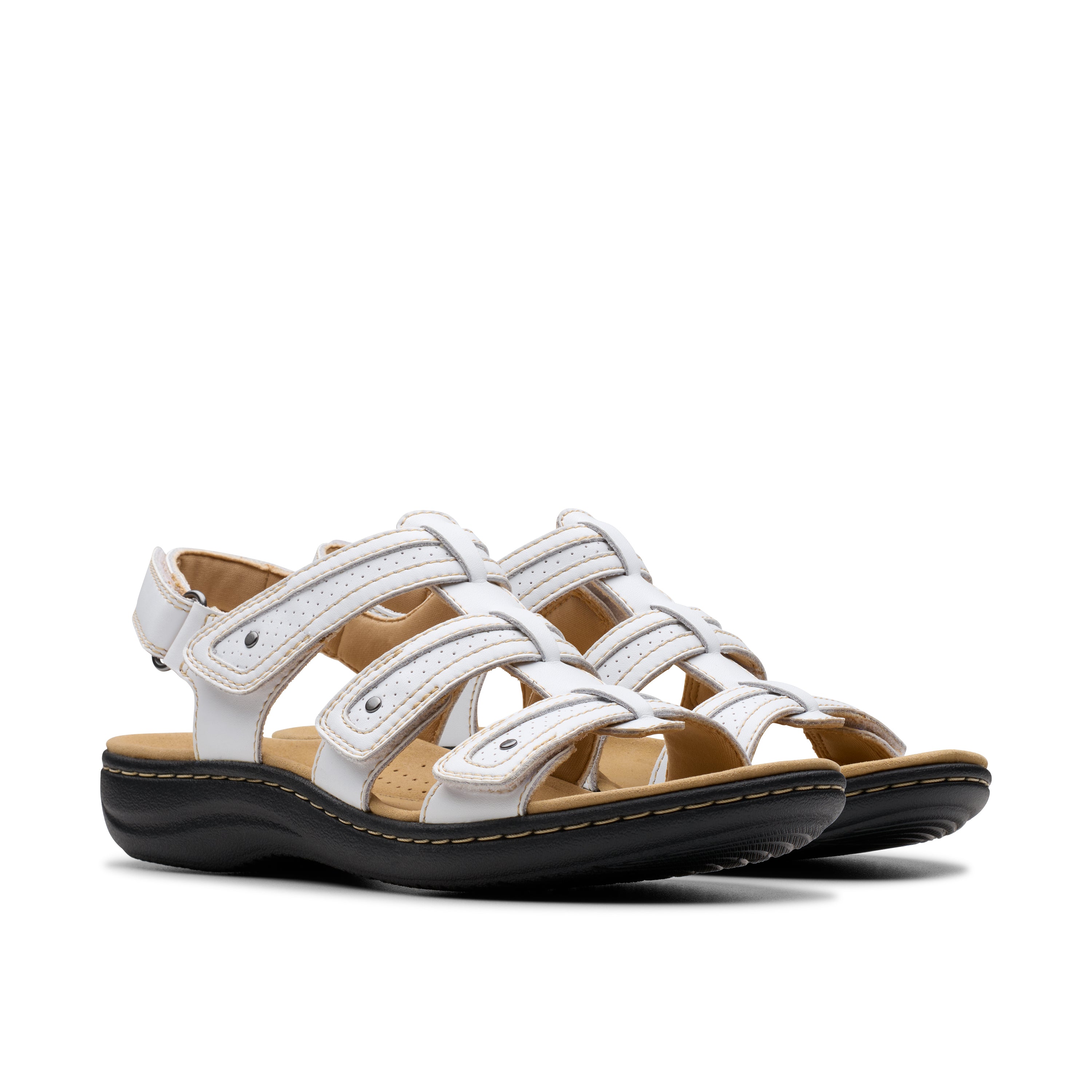 Pair of white sandals with brown soles on a white background