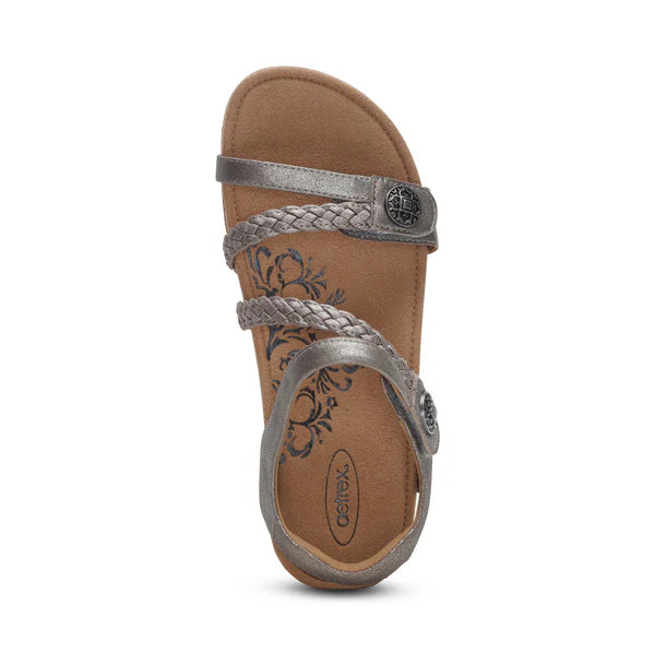 Brown sandal with silver straps on a white background