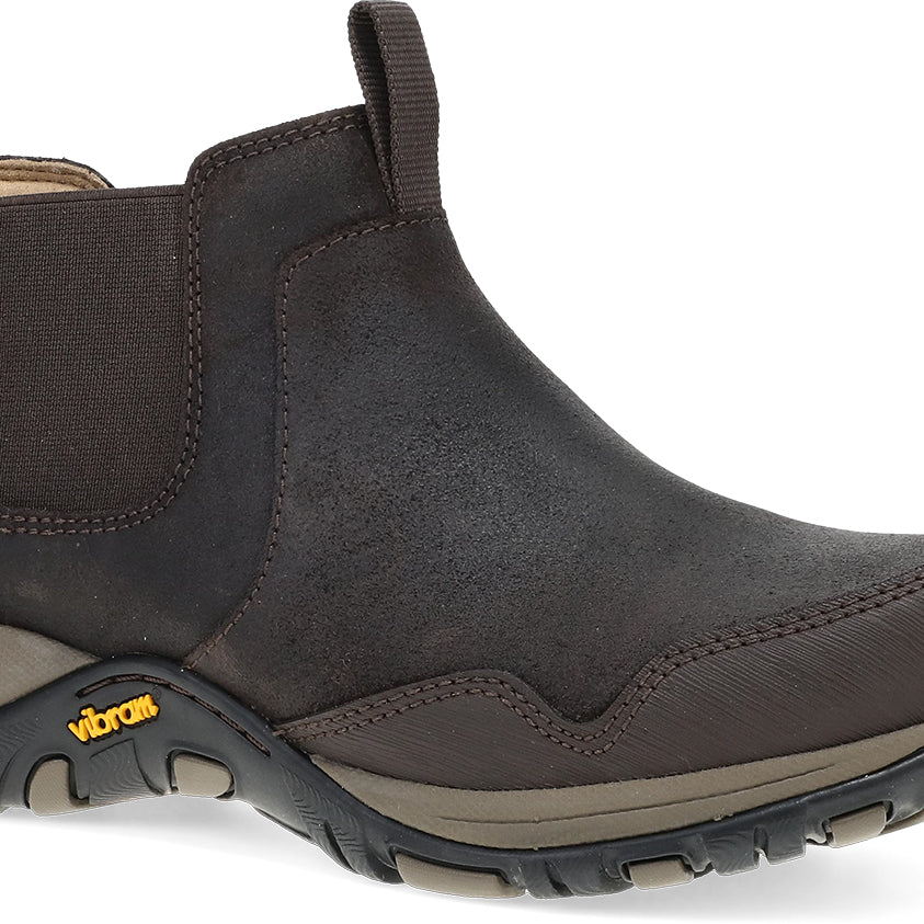 A dark brown Chelsea-style ankle boot with elastic side panels and a Vibram sole, shown from a three-quarters angle on a white background.