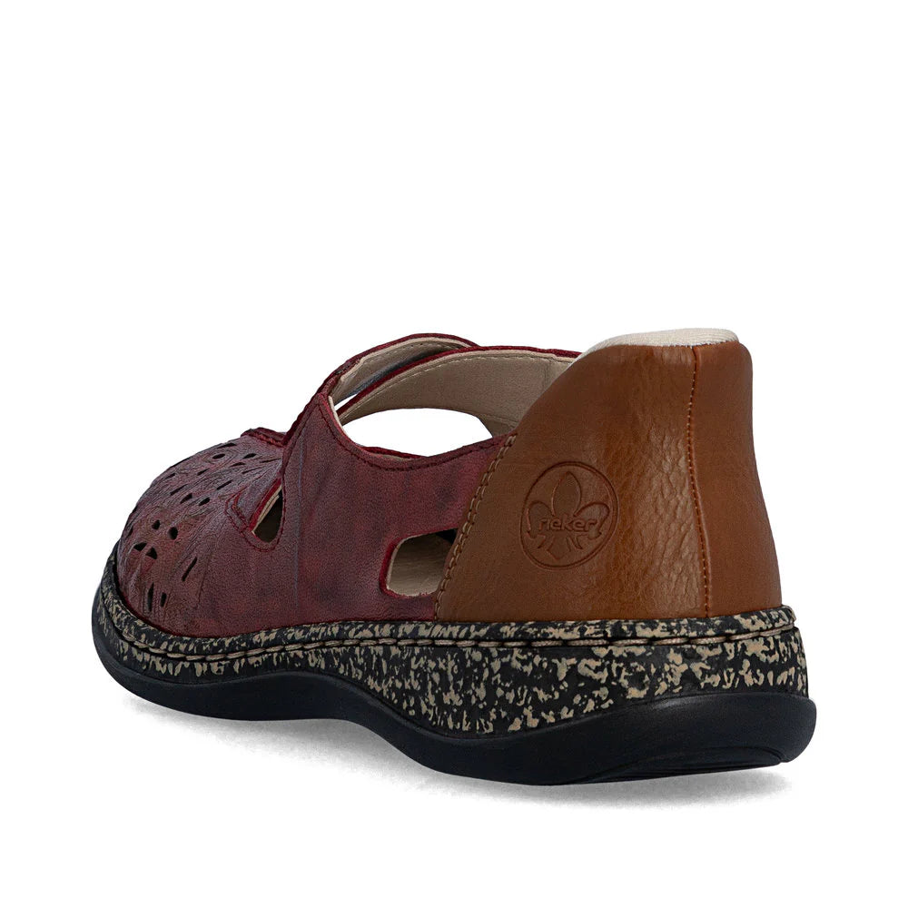Brown sandal with a patterned sole on a white background
