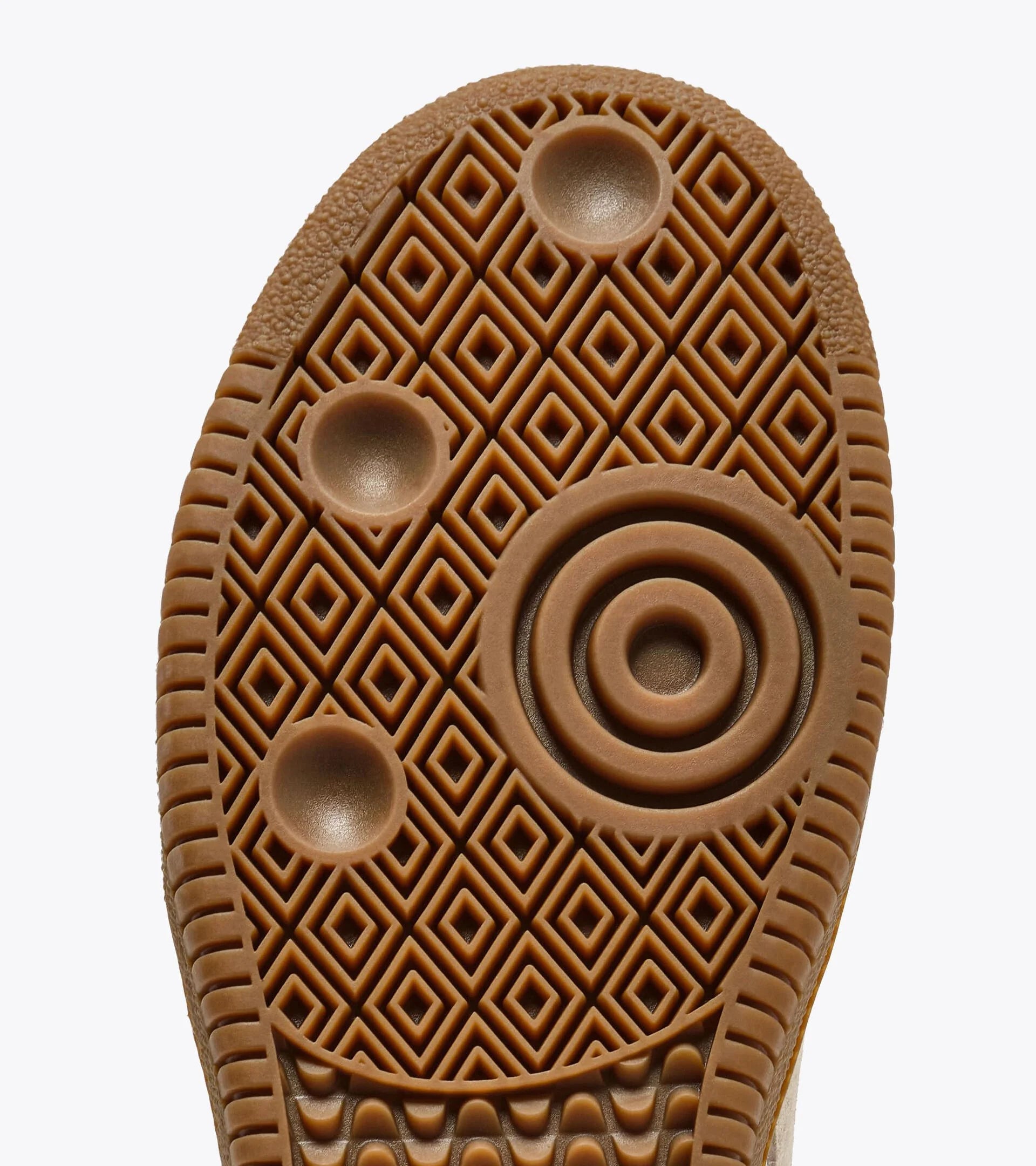 Close-up of a brown shoe sole with geometric pattern on a white background