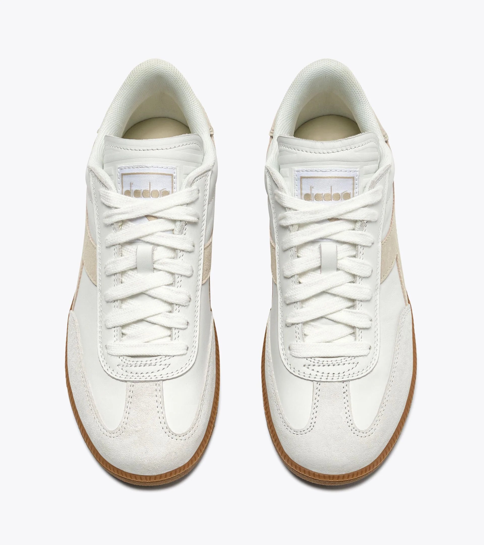 White sneakers with brown soles on a white background