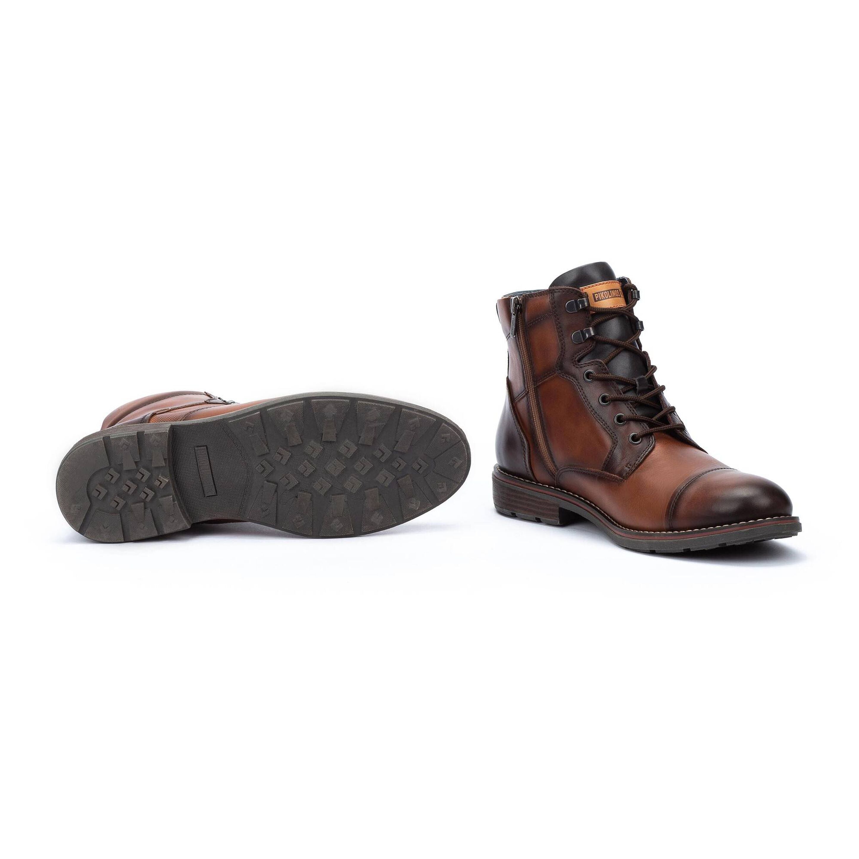 Brown leather boot with sole showing on a white background