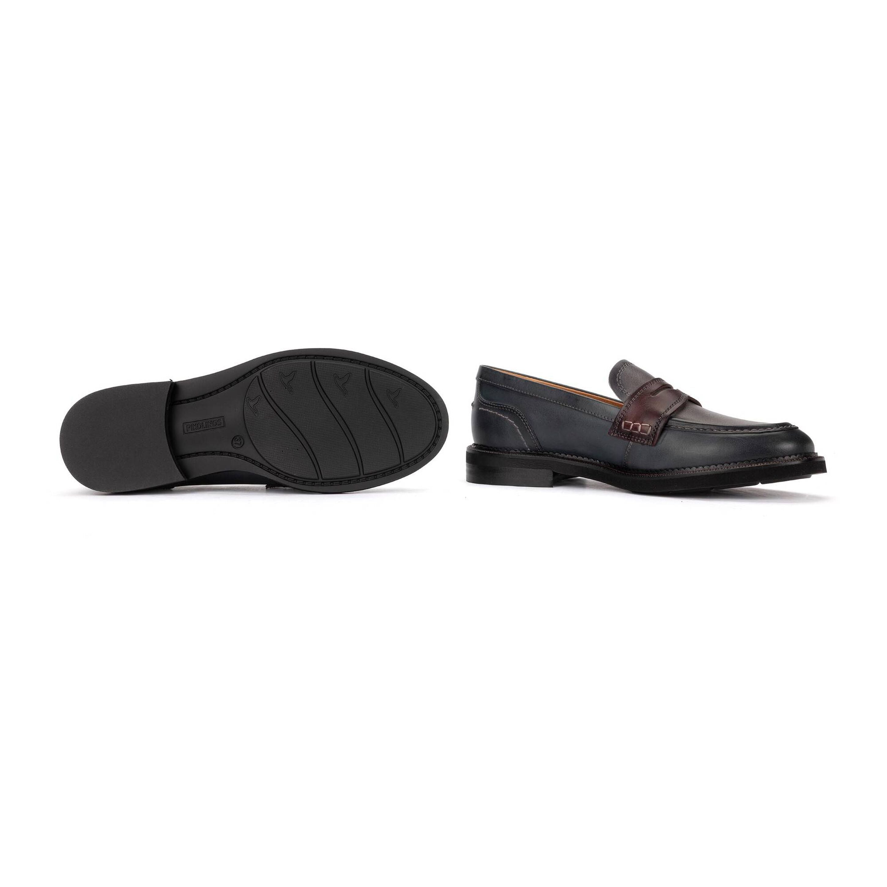 A pair of men's black leather penny loafers shown from the side and sole views against a plain white background.
