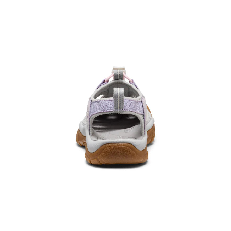 Back view of a sandal with brown sole and white upper on a white background