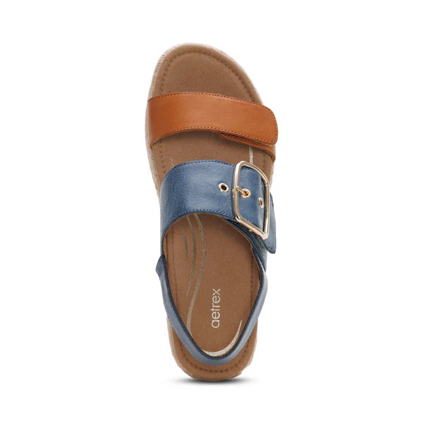 Blue sandal with brown strap and buckle on a white background