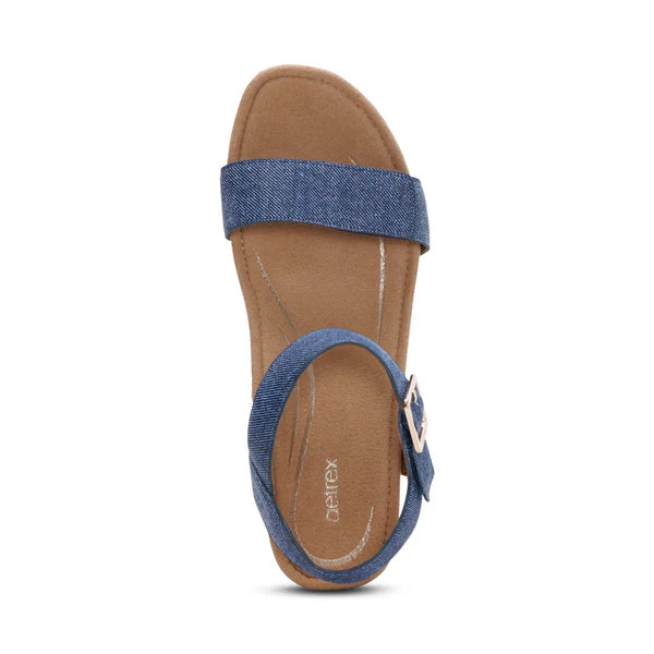 Brown sandal with blue straps on a white background