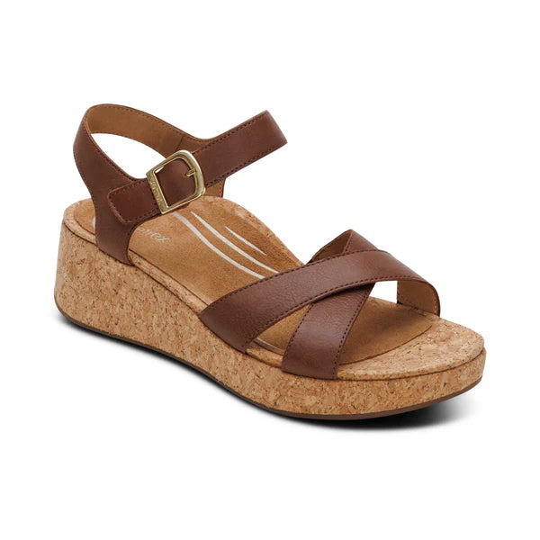 Brown wedge sandal with cork sole on a white background
