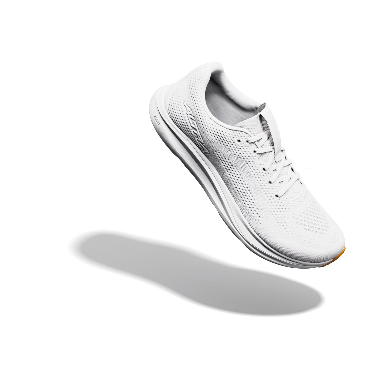 A white athletic sneaker with a breathable mesh upper and thick cushioned sole, shown floating at an angle against a solid white background with a soft shadow underneath.