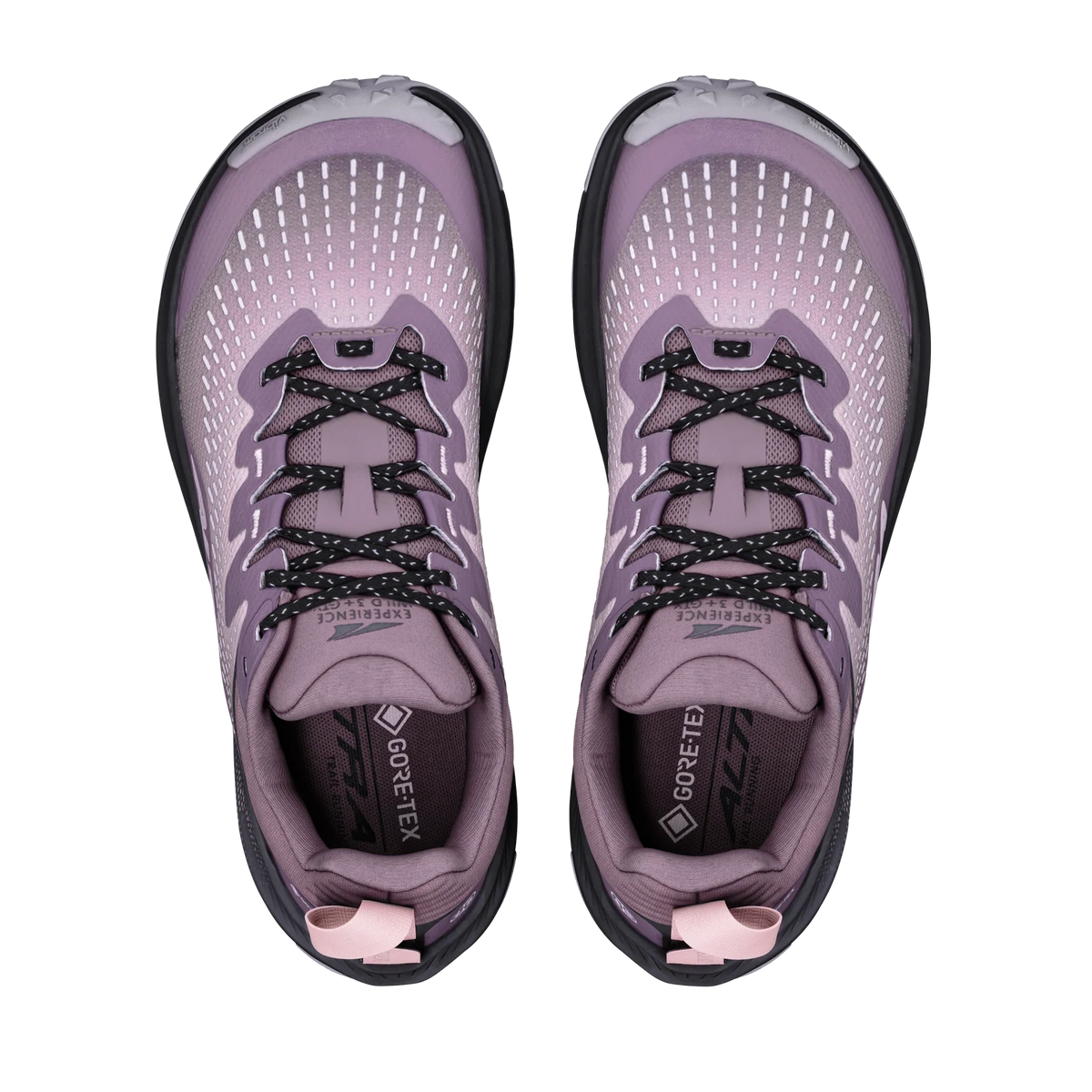 A pair of women's trail running shoes in a dusty lavender-purple colorway, shown from a top-down view on a solid white background. The shoes feature a breathable mesh upper, black and white speckled laces, a black and white outsole, and a pink pull tab at the heel.