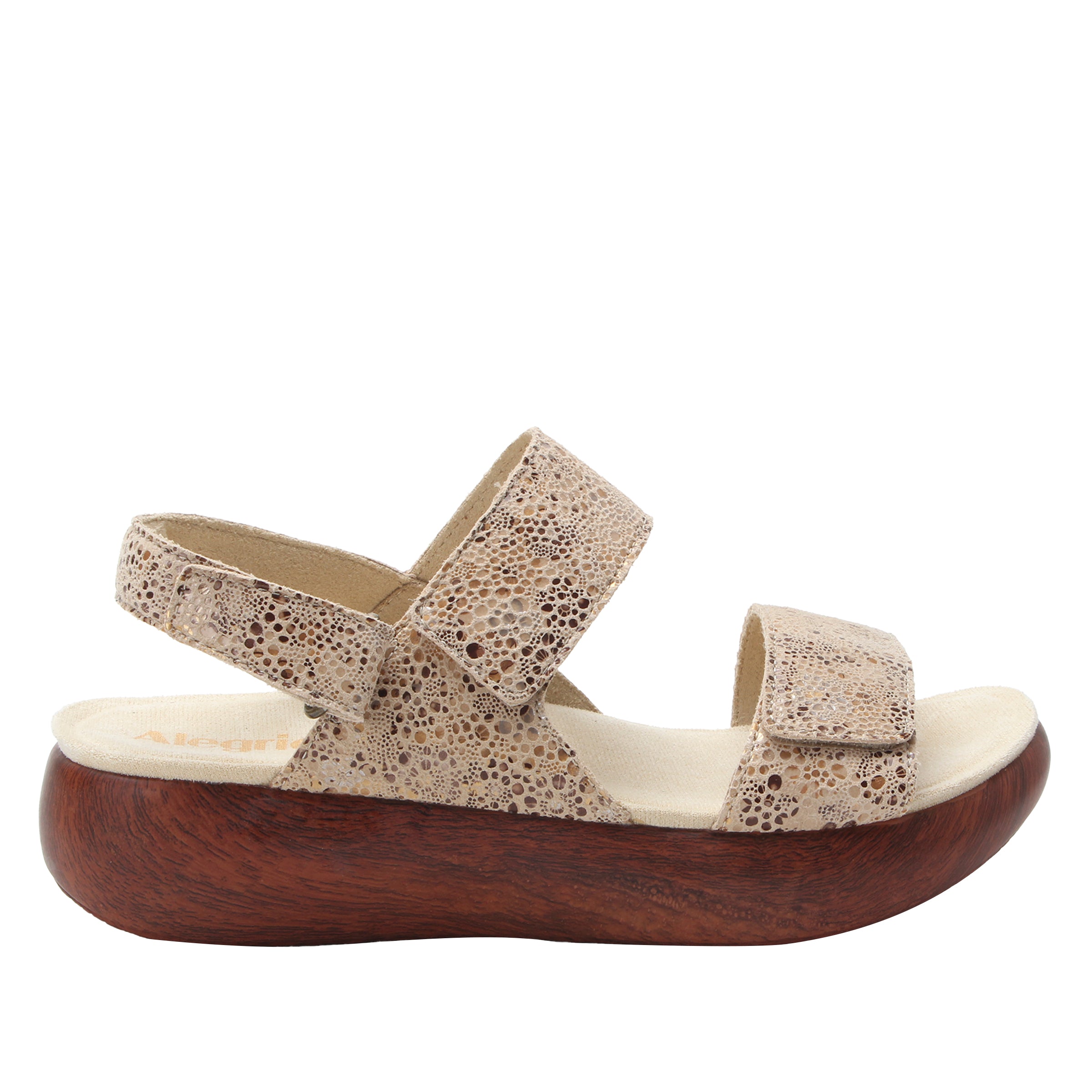 Sandal with wooden sole and patterned strap on a white background