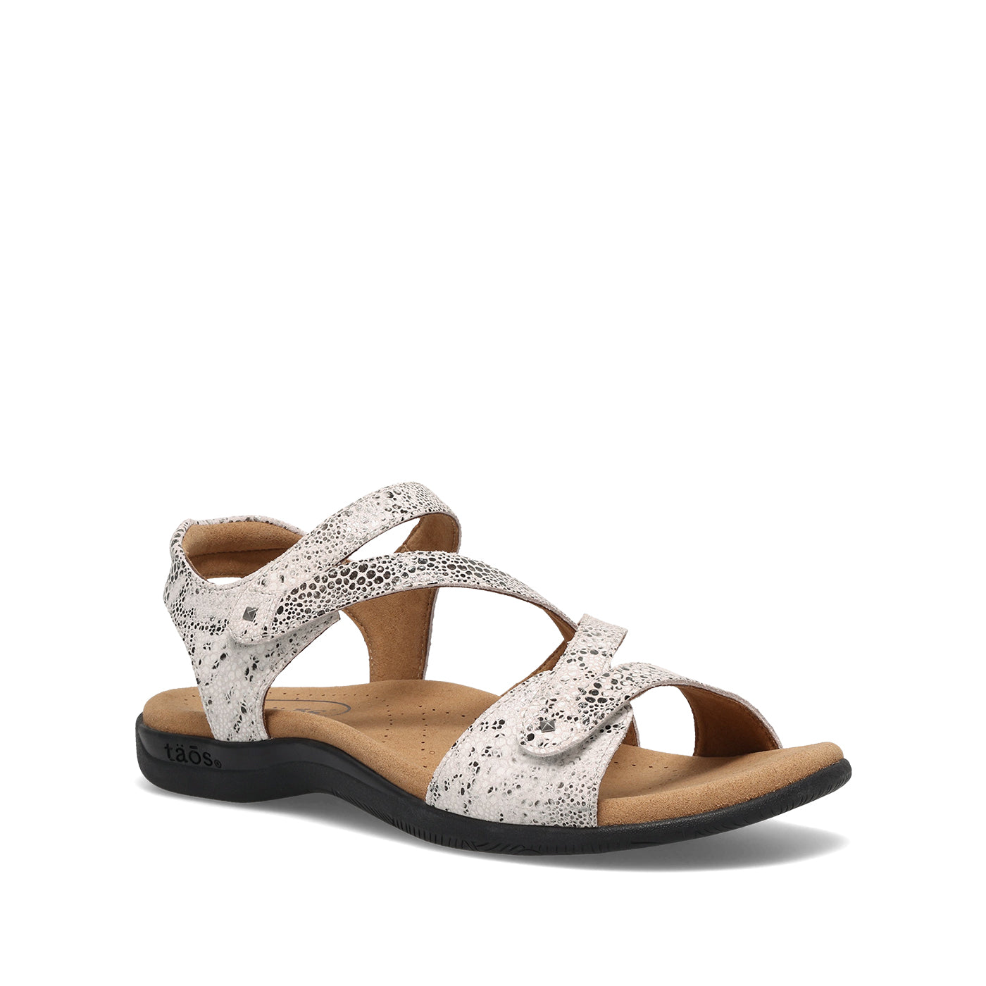 White sandal with black speckles on a white background