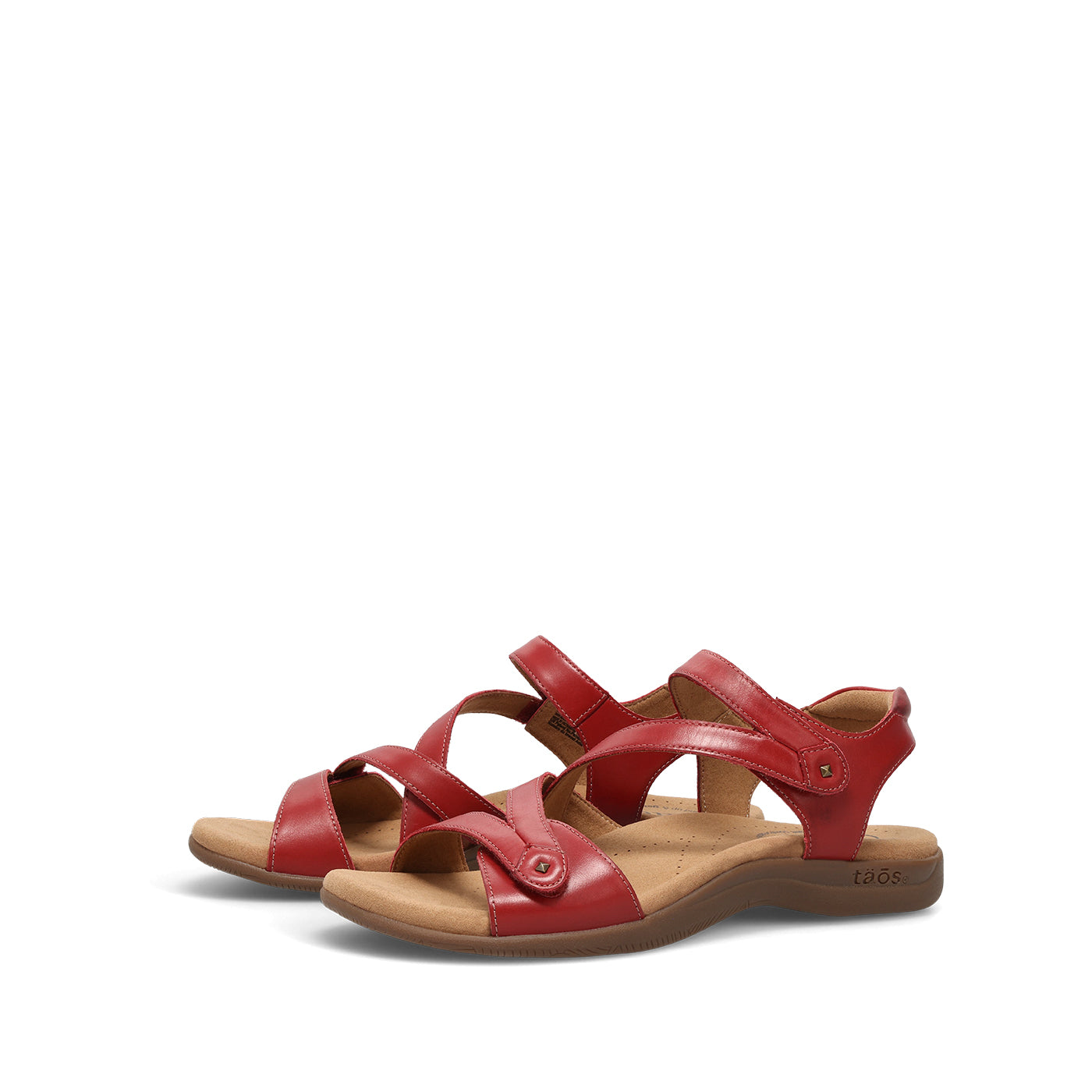 Red sandals with brown soles on a white background