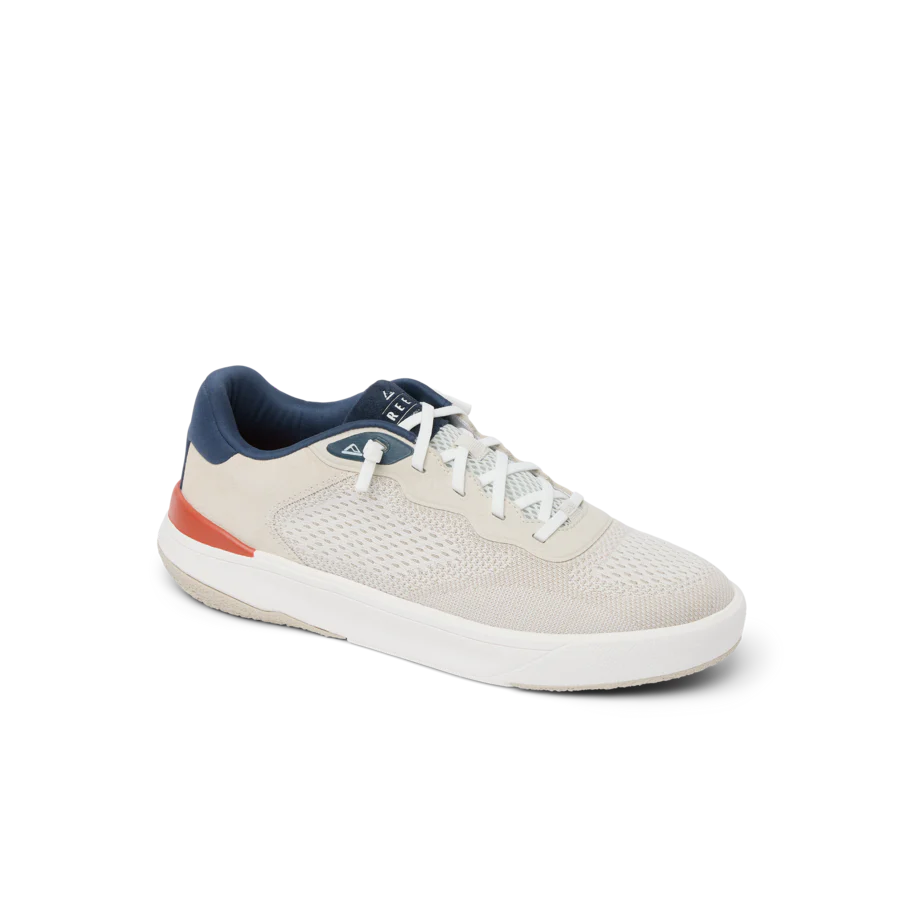 White sneaker with blue and red accents on a white background