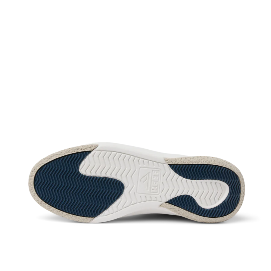White sneaker sole with blue tread pattern on a white background