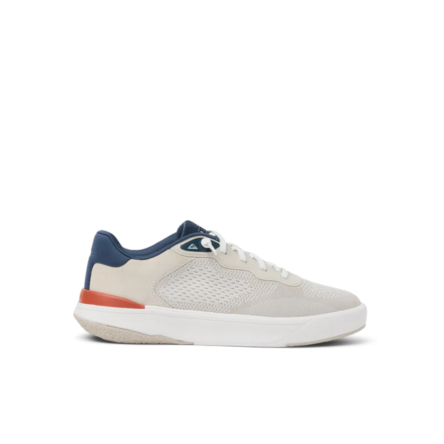 White sneaker with blue and red accents on a white background