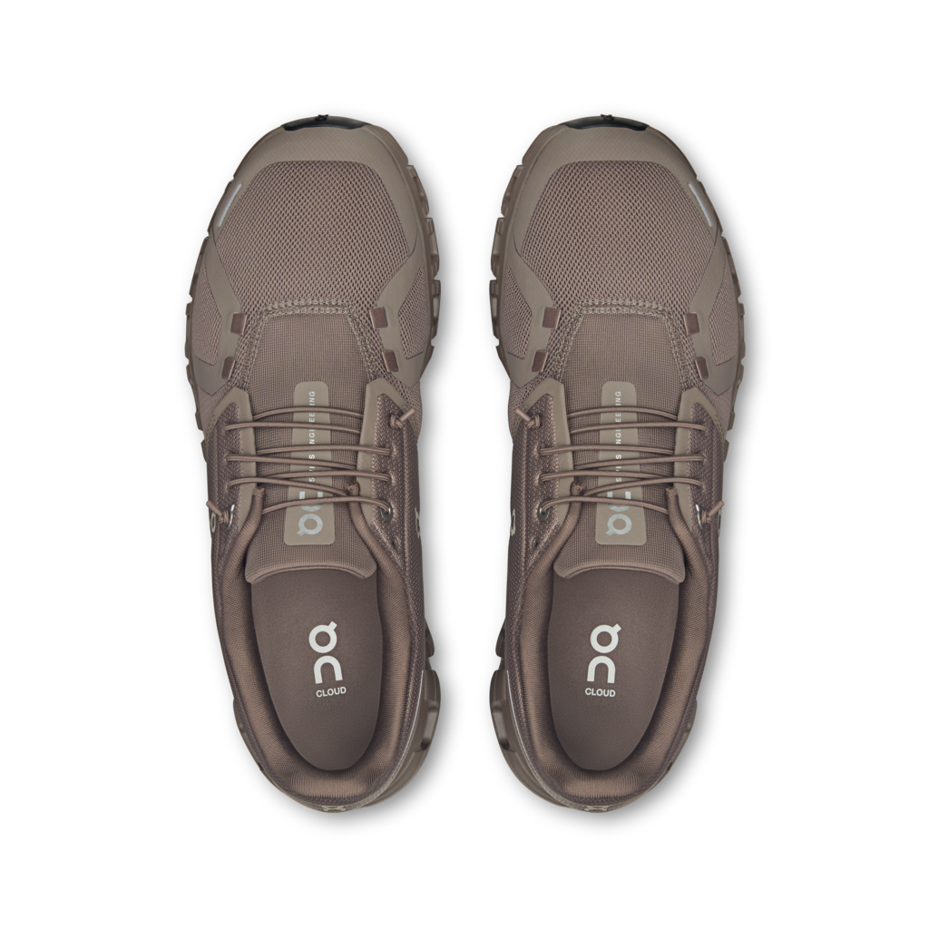Pair of brown athletic shoes on a white background