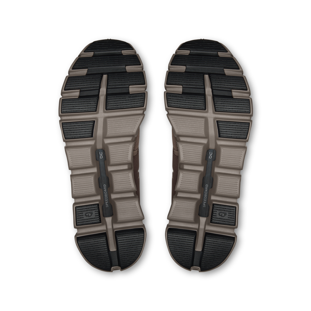 Top view of a pair of hiking shoes with tread pattern on a white background
