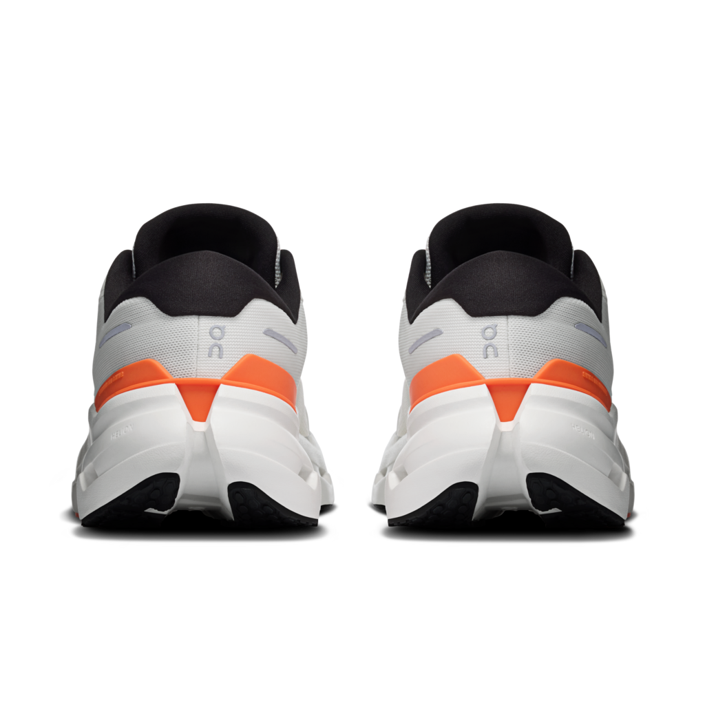 Pair of running shoes with orange accents on a white background