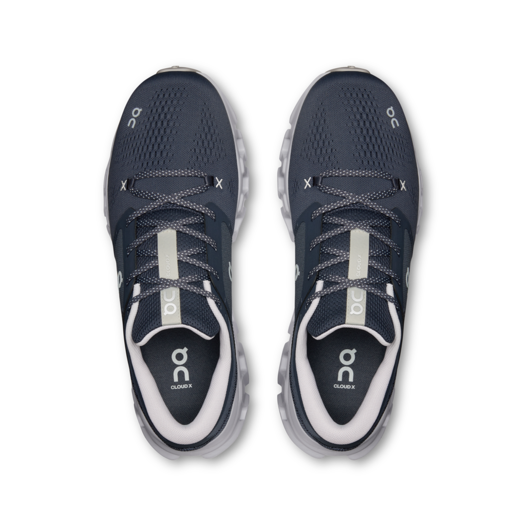 A pair of On Cloudrunning sneakers in navy blue and white, shown from a top-down view on a white background.