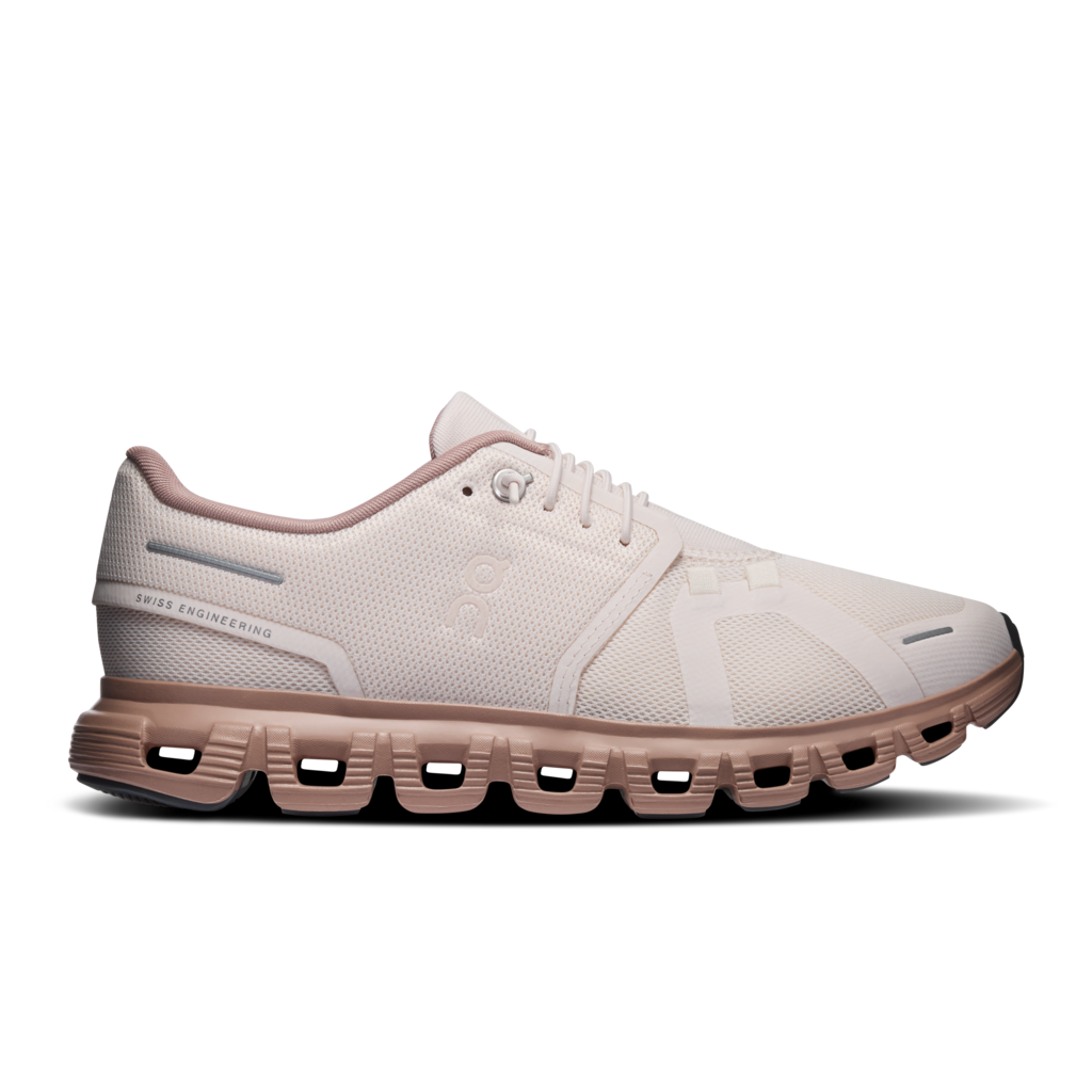 White running shoe with pink accents on a white background