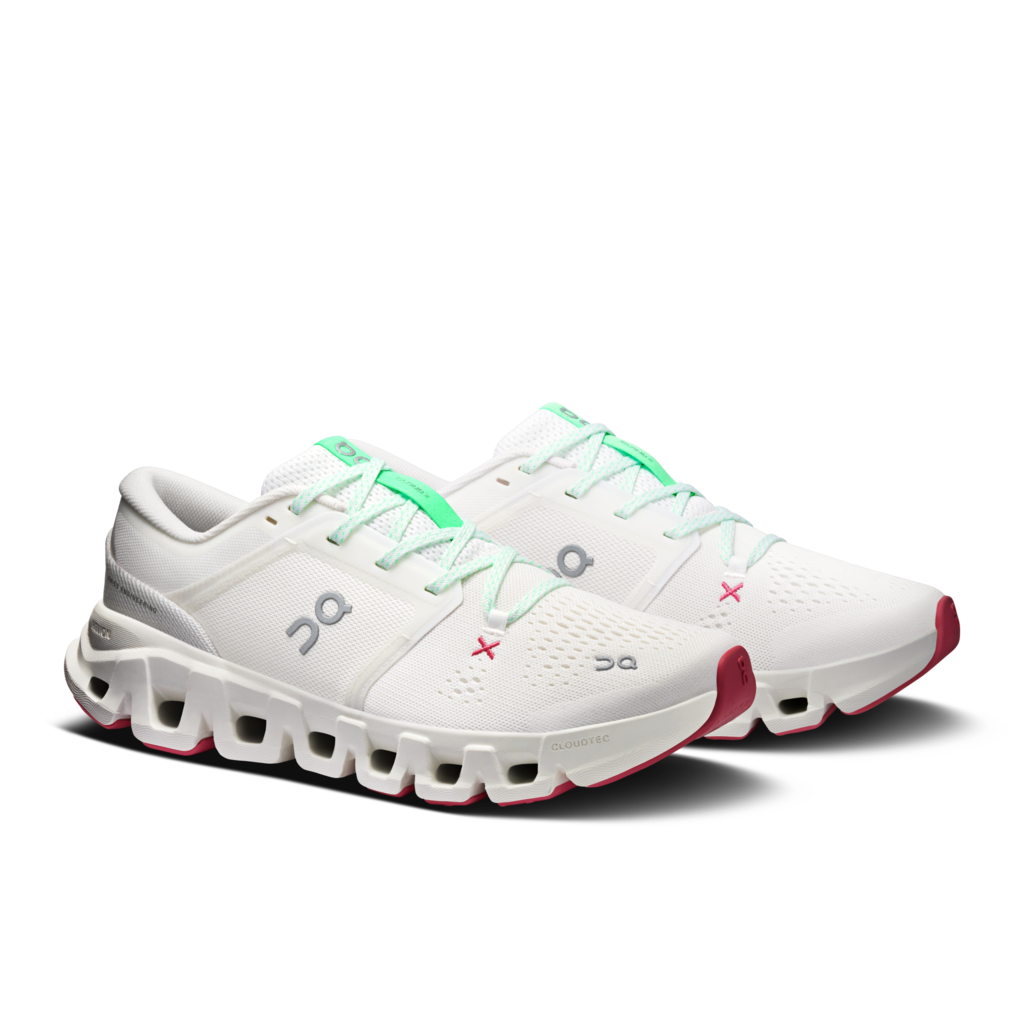 A pair of white On running shoes with mint green laces and accents, and red outsole details, shown on a clean white background.