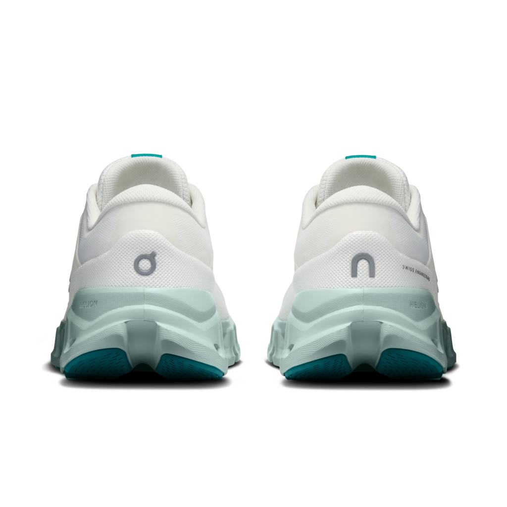 A pair of On running shoes shown from the back, featuring a white upper, a translucent mint green midsole, and teal outsole details.
