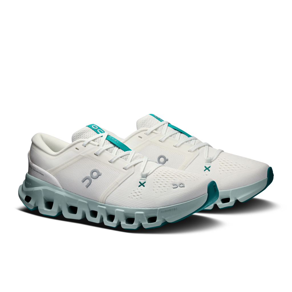 A pair of On Cloudrunning shoes in white with teal accents, featuring the On logo on the side and a distinctive cloud-like sole, set against a plain white background.