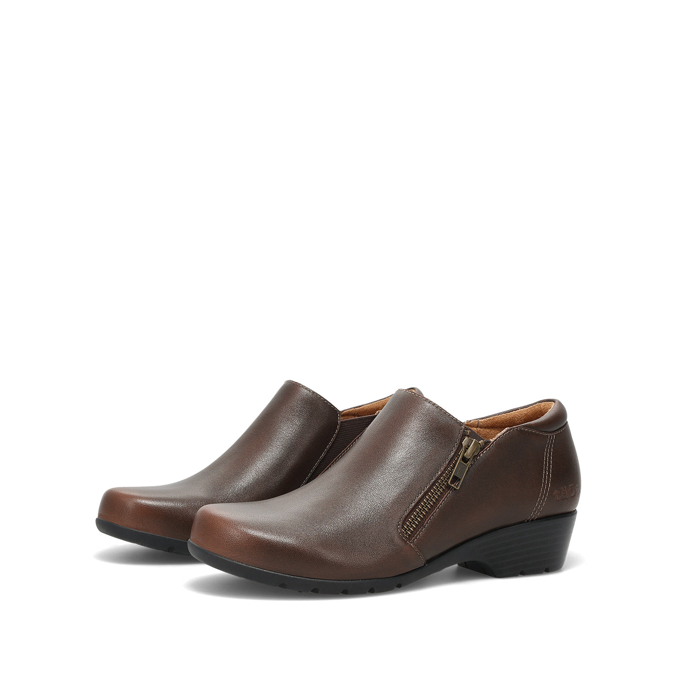 A pair of women's brown leather slip-on bootie with a side zipper and low wedge heel, shown on a plain white background.