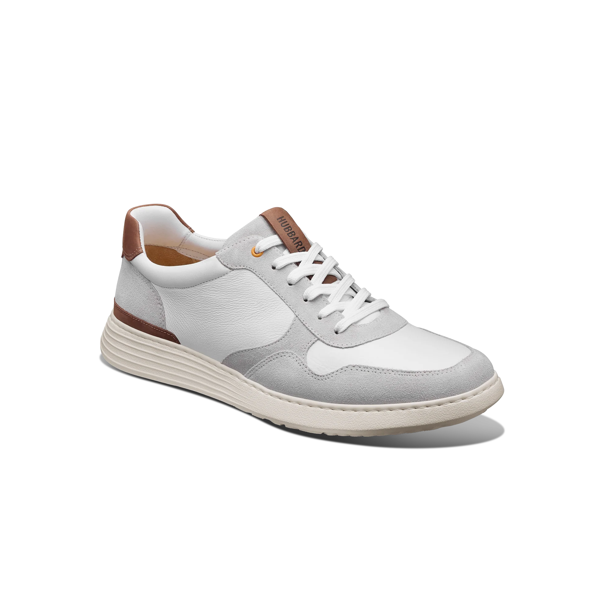 White sneaker with brown accents on a white background