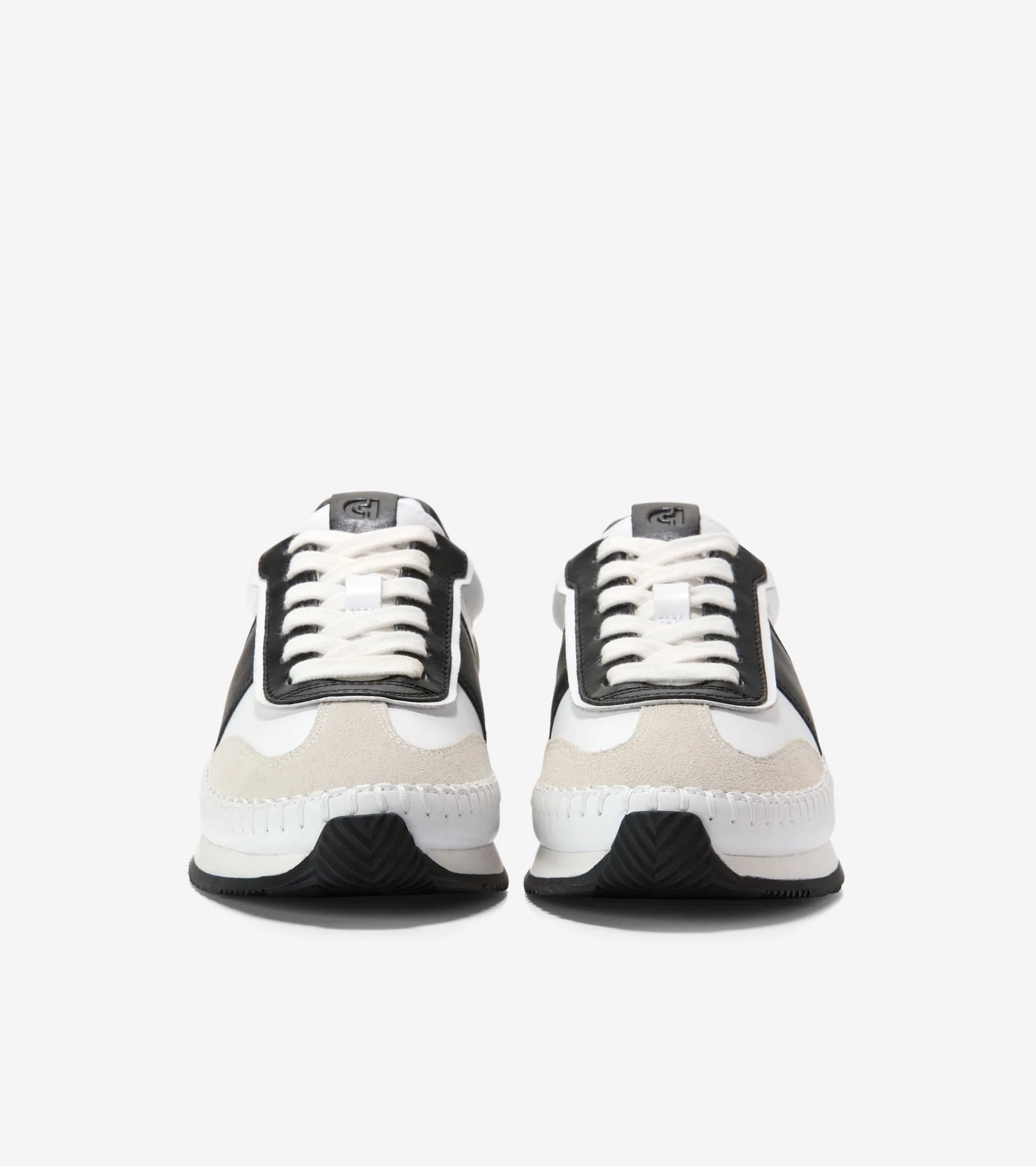 Pair of black and white sneakers on a light gray background