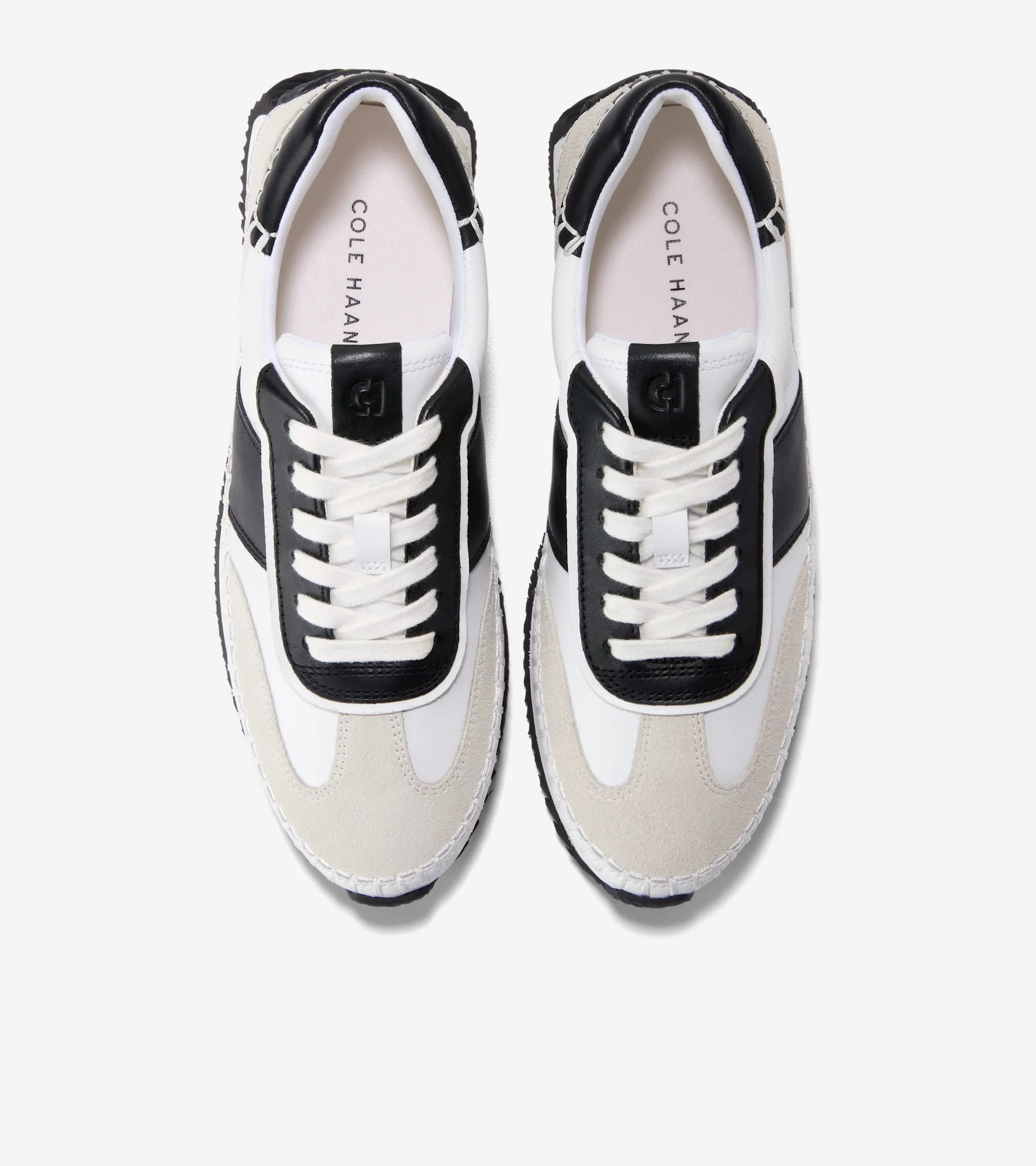 Pair of Cole Haan sneakers with black and white design on a white background