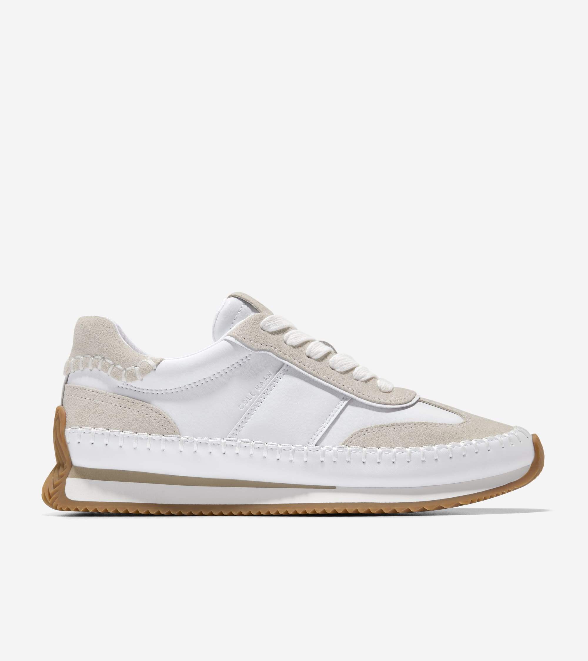 White sneaker with beige accents on a white background