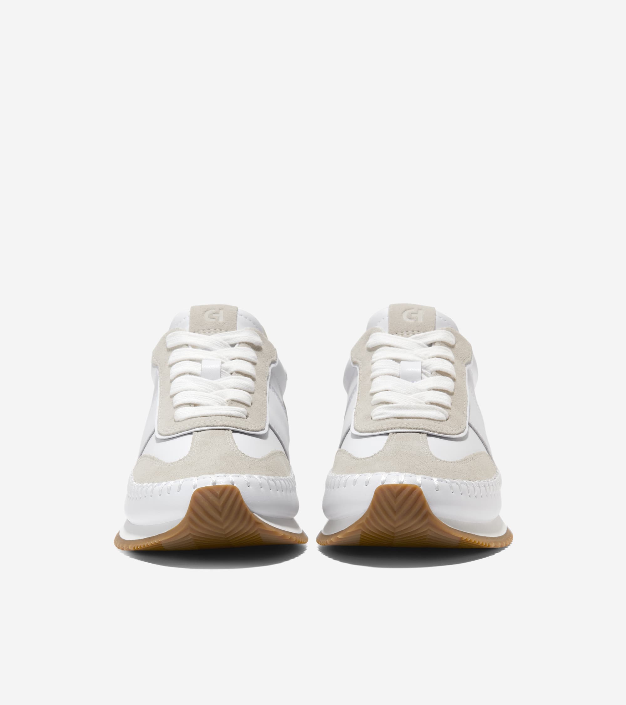 White sneakers with brown soles on a white background