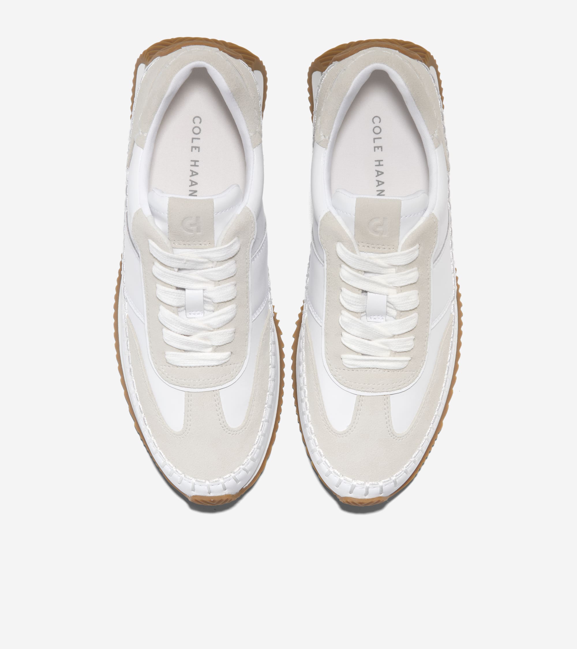 White sneakers with brown soles on a white background