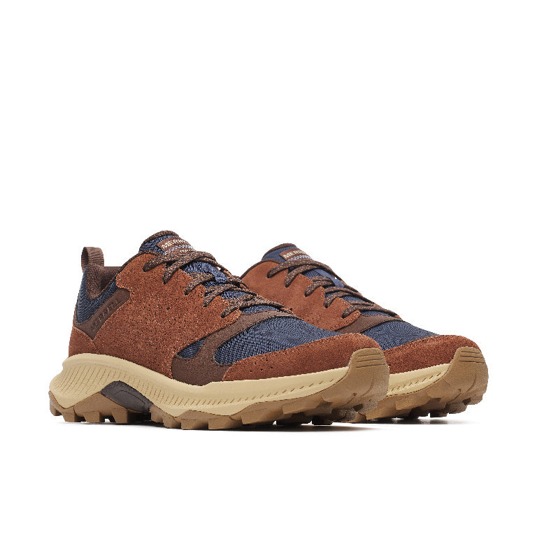 A pair of rugged low-top sneakers in brown suede and navy blue mesh, featuring beige midsoles and lugs, shown against a plain white background.