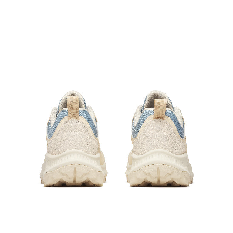 Pair of beige sneakers with blue accents on a white background