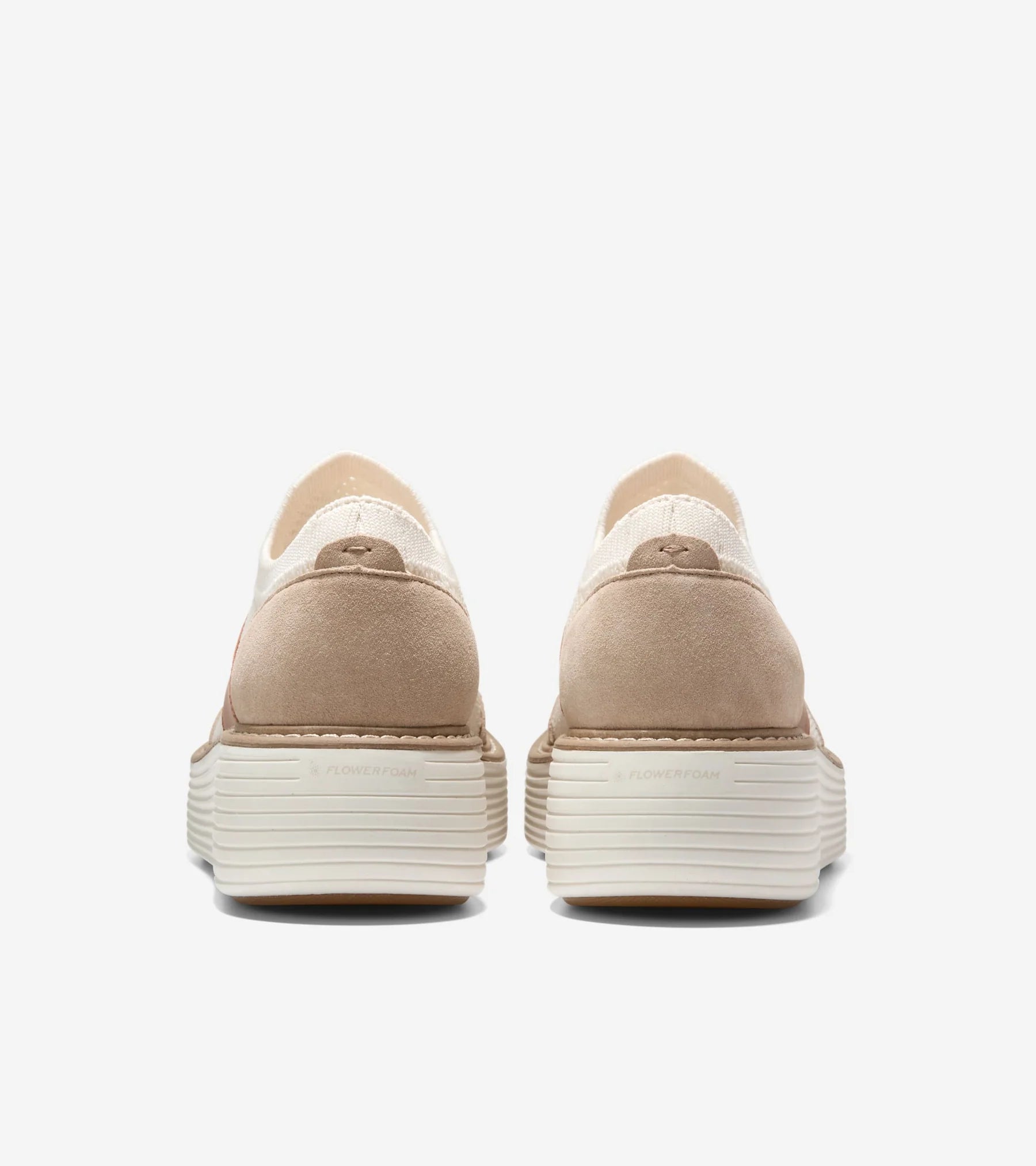 Pair of beige platform shoes on a white background