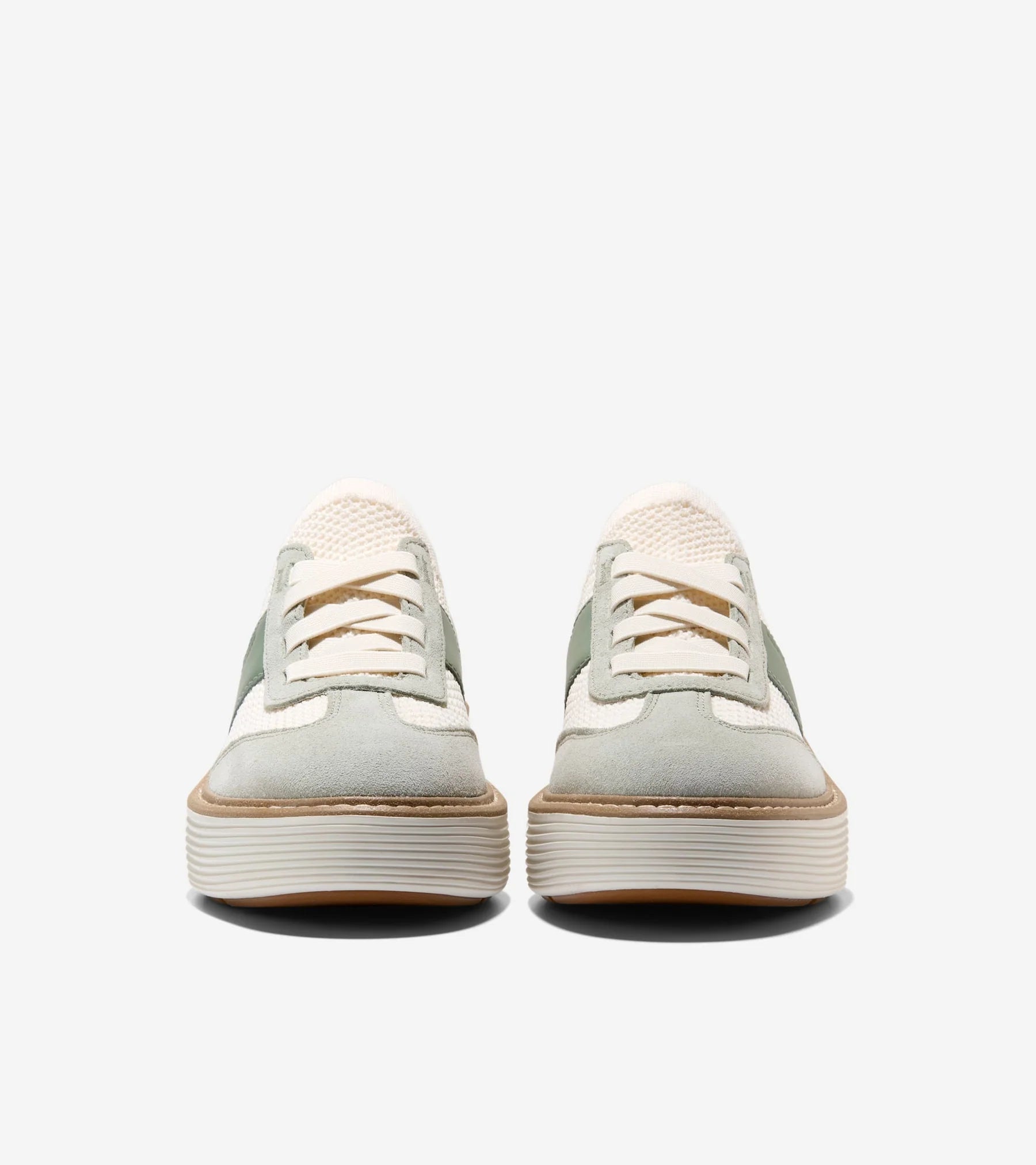 Pair of light green sneakers with white soles on a white background