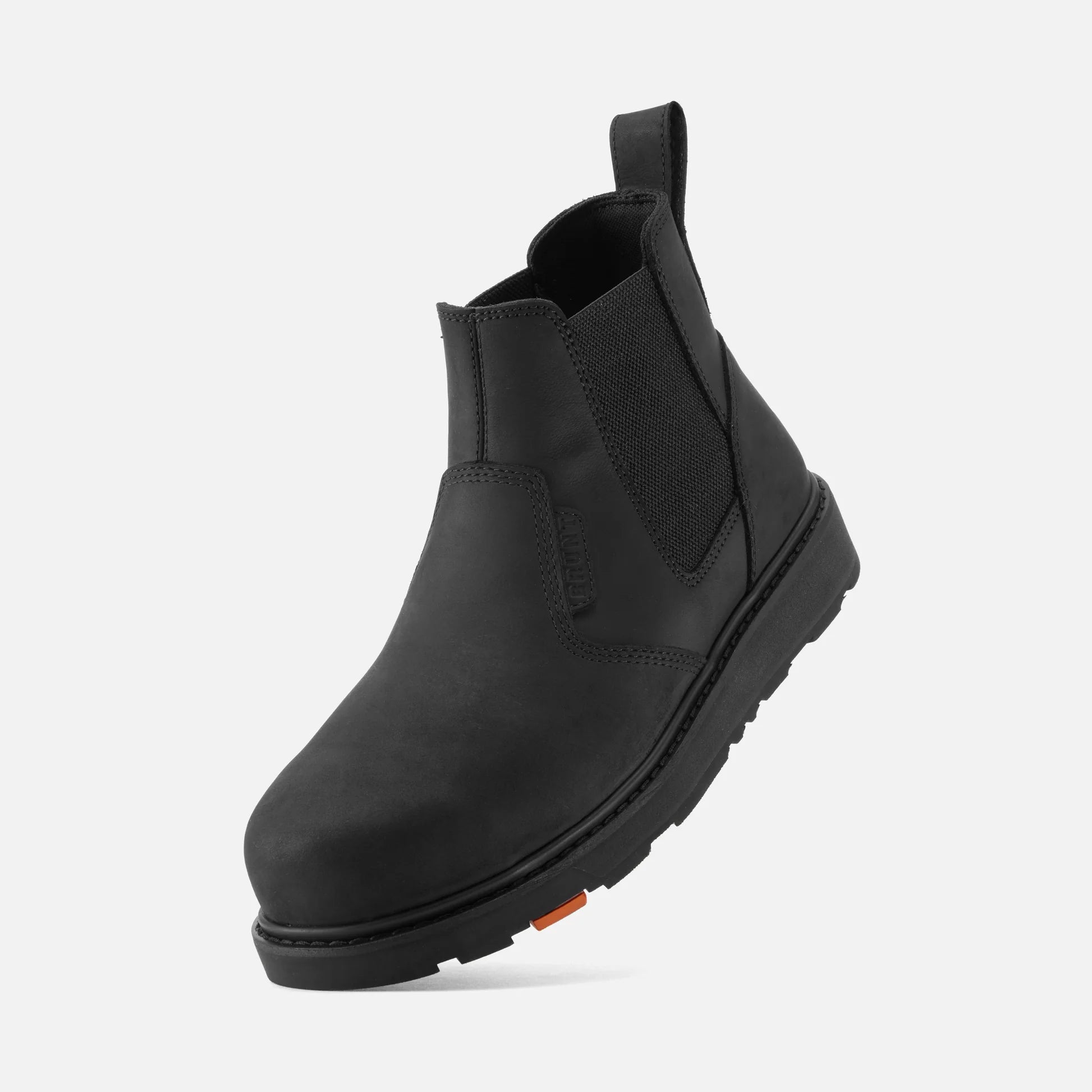 Black Chelsea boot on a light gray background