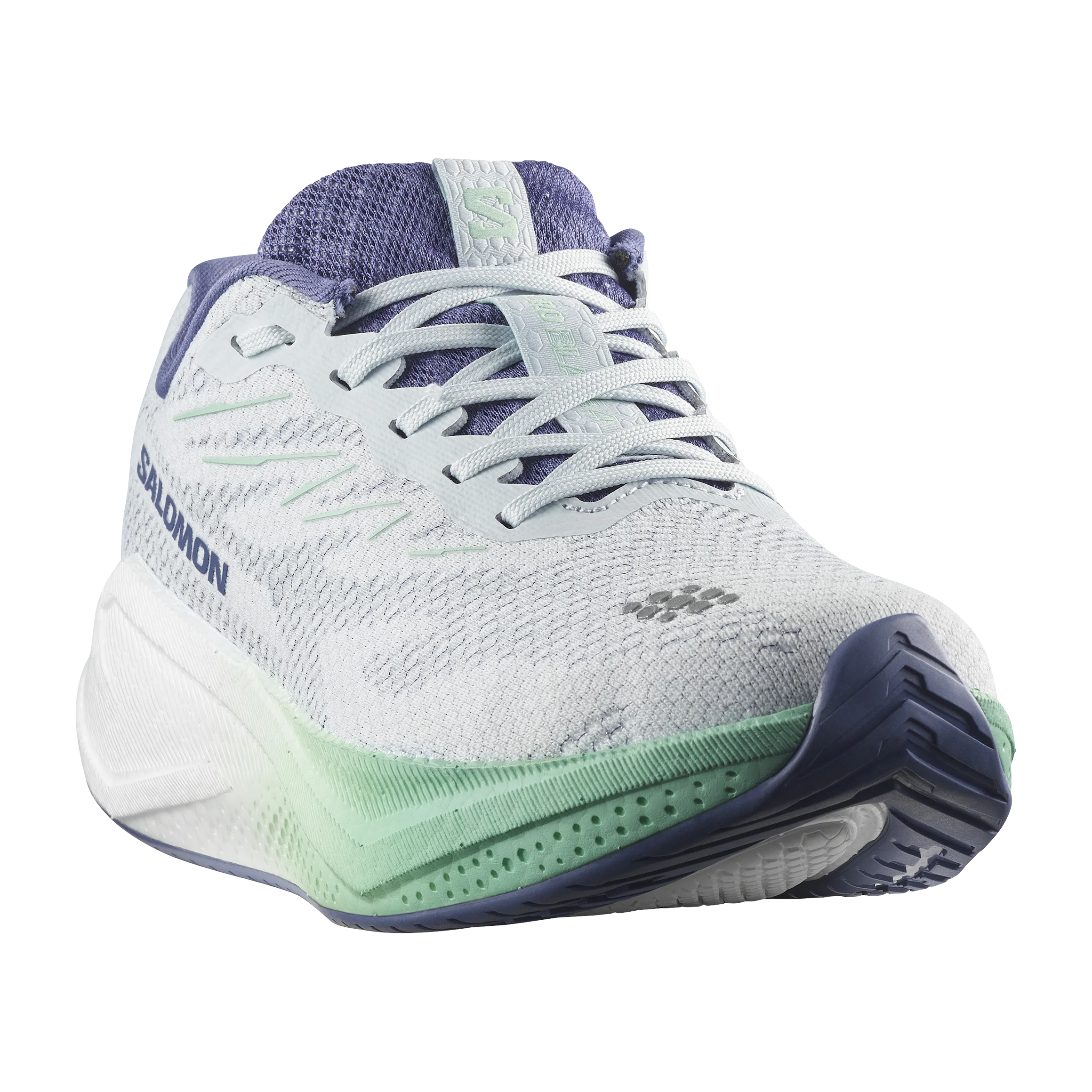 A Salomon running shoe in white and light purple with mint green accents, shown from a three-quarters angle on a white background.