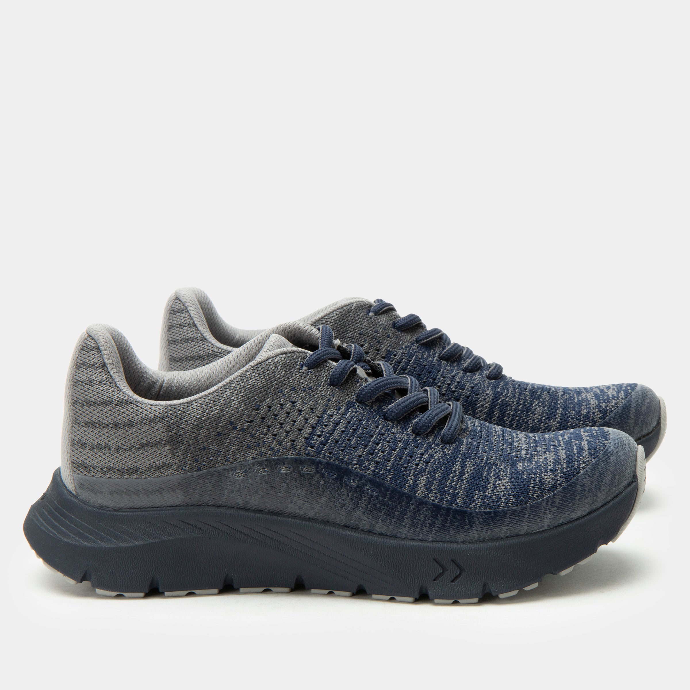 Pair of gray and blue running shoes on a light gray background