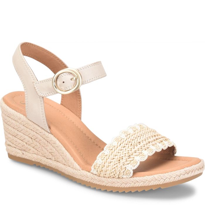Beige wedge sandal with a strap and textured sole on a white background