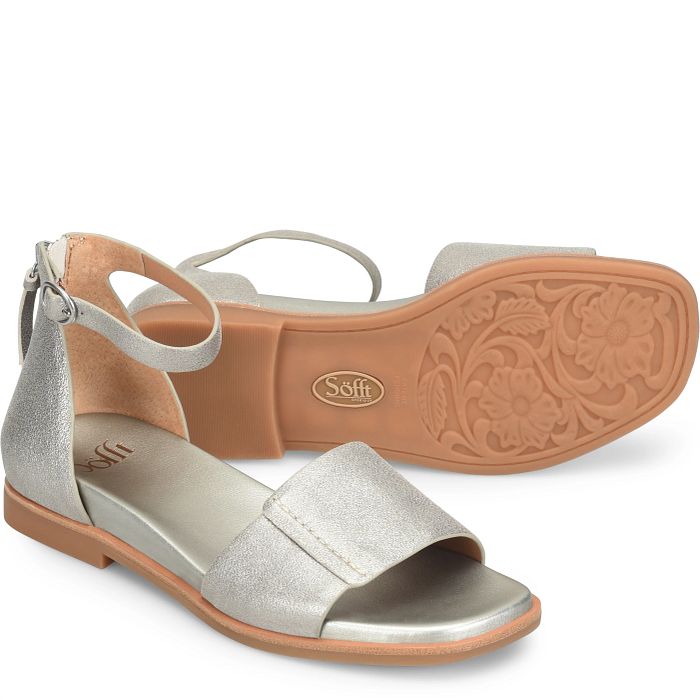 Silver sandal with tan sole on a white background
