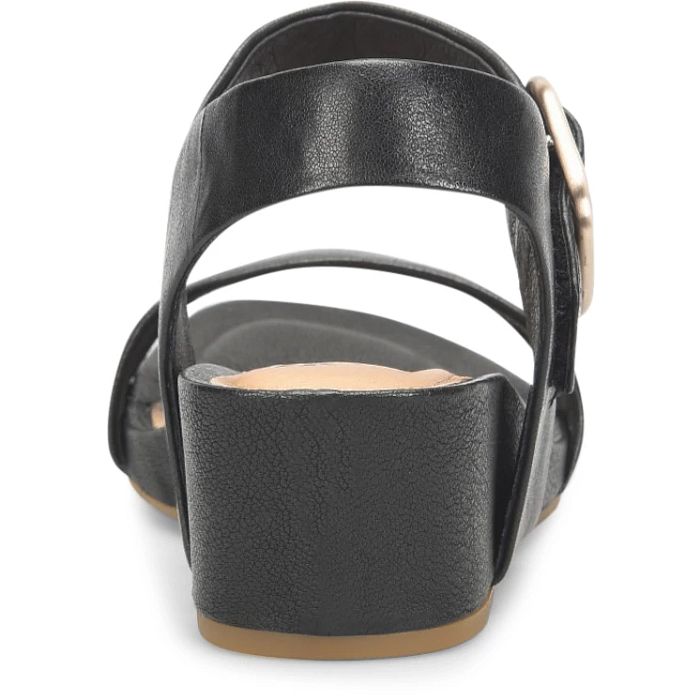 Black sandal with a strap and buckle on a white background
