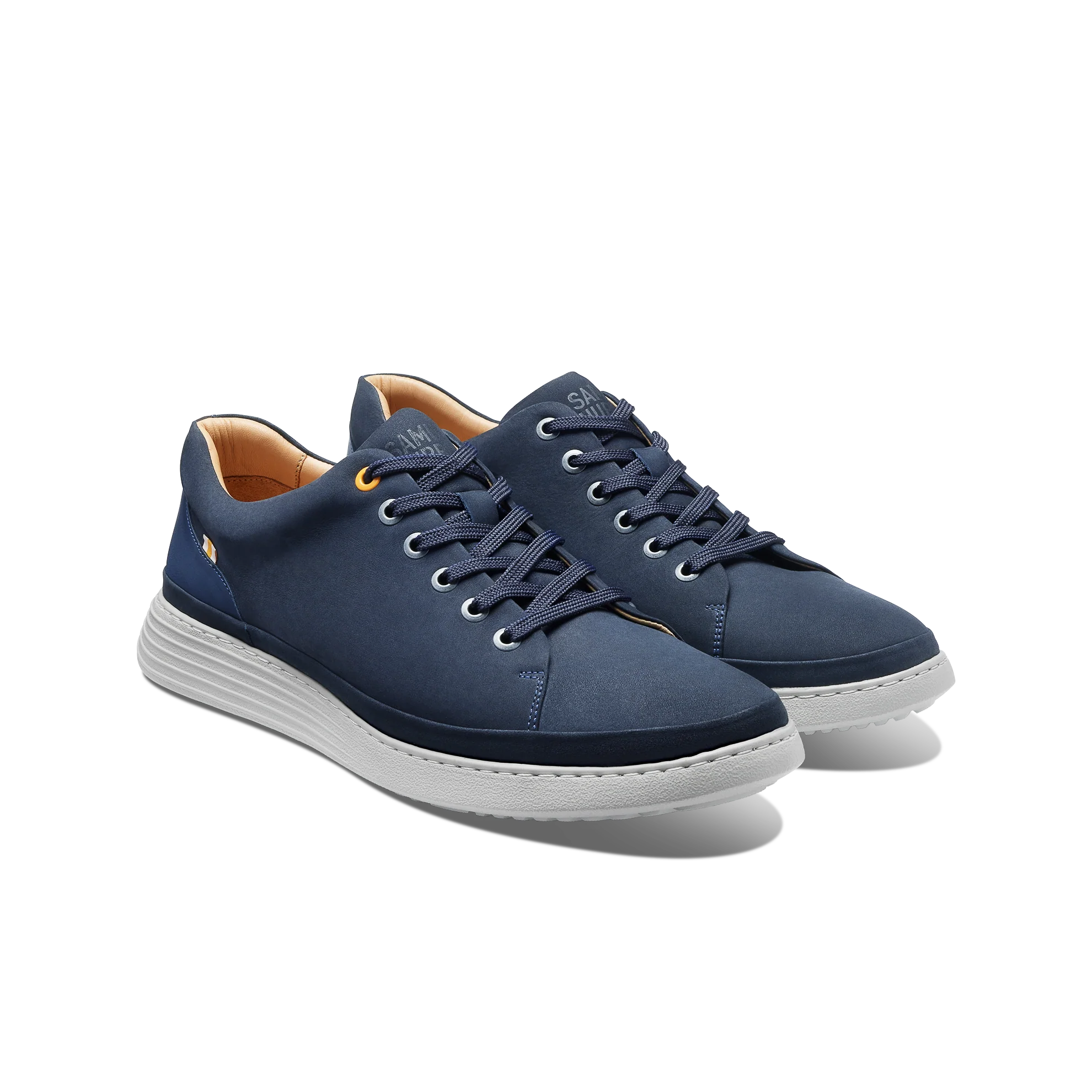 Pair of navy blue sneakers with white soles on a white background