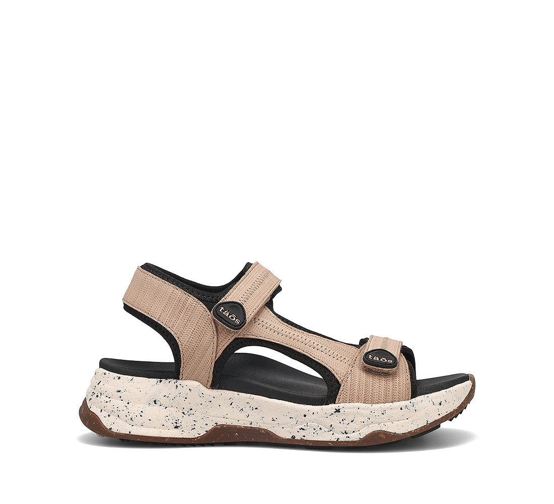 Beige sandal with black accents on a white background