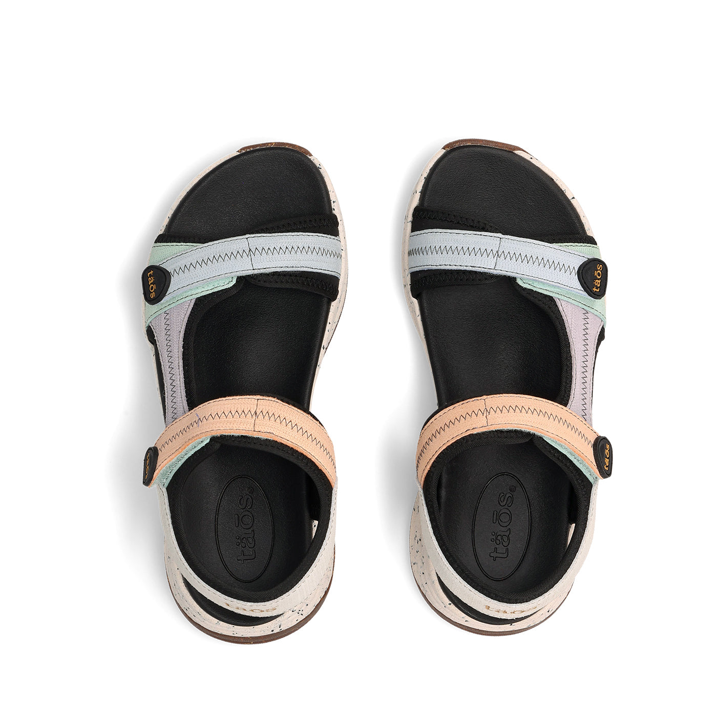 Pair of sandals with black soles and colorful straps on a white background